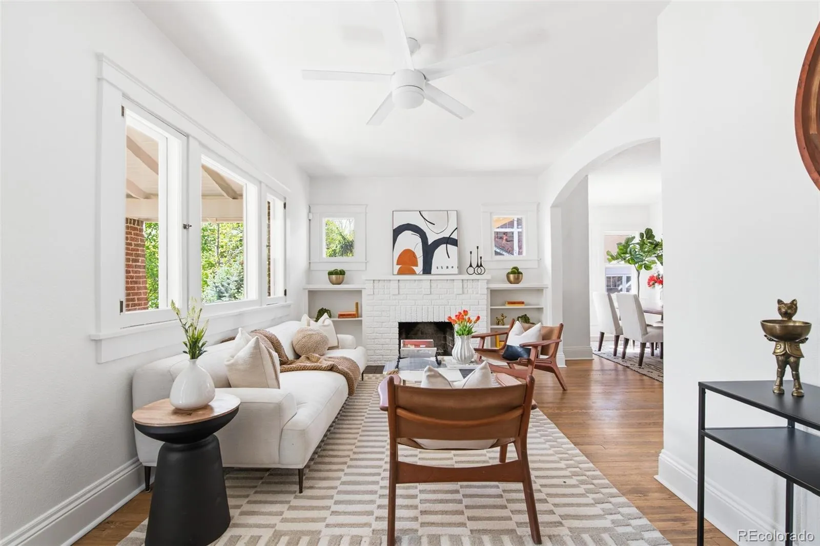 Bright living room with fireplace and oversized windows